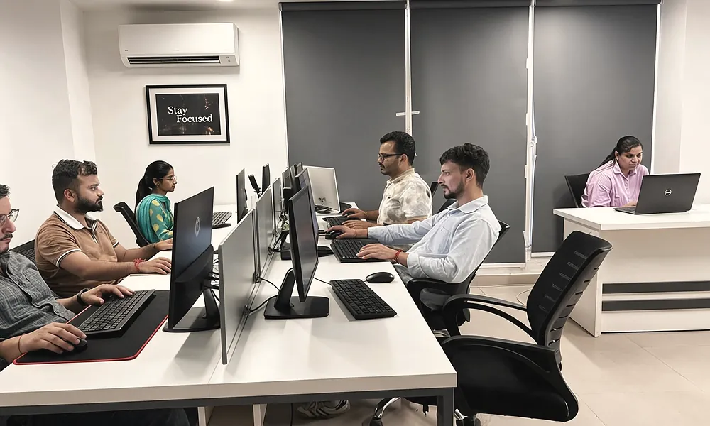Colleagues working at desks in the office