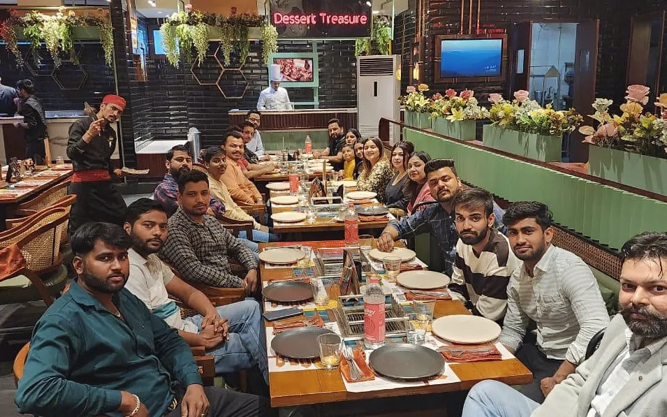 The team along a long restaurant table